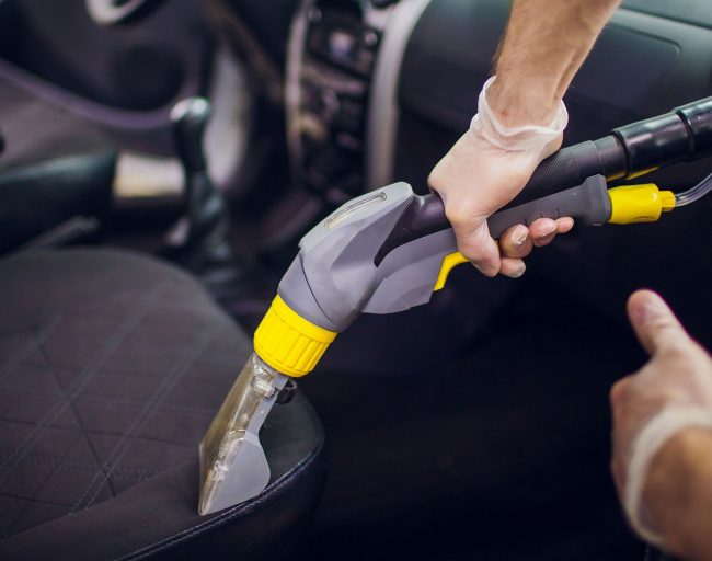 Car interior textile seats chemical cleaning with professionally extraction method. Early spring cleaning or regular clean up.